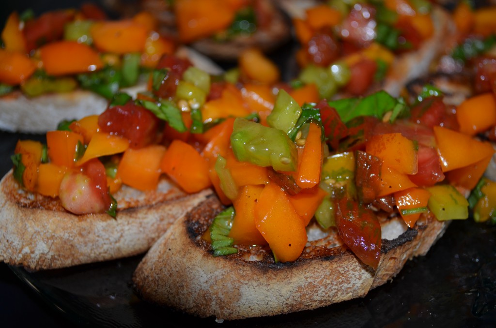 Colorful red, yellow and green tomatoes on toasted baguette
