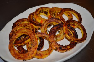 rings of roasted delicate squash on a white oval plate