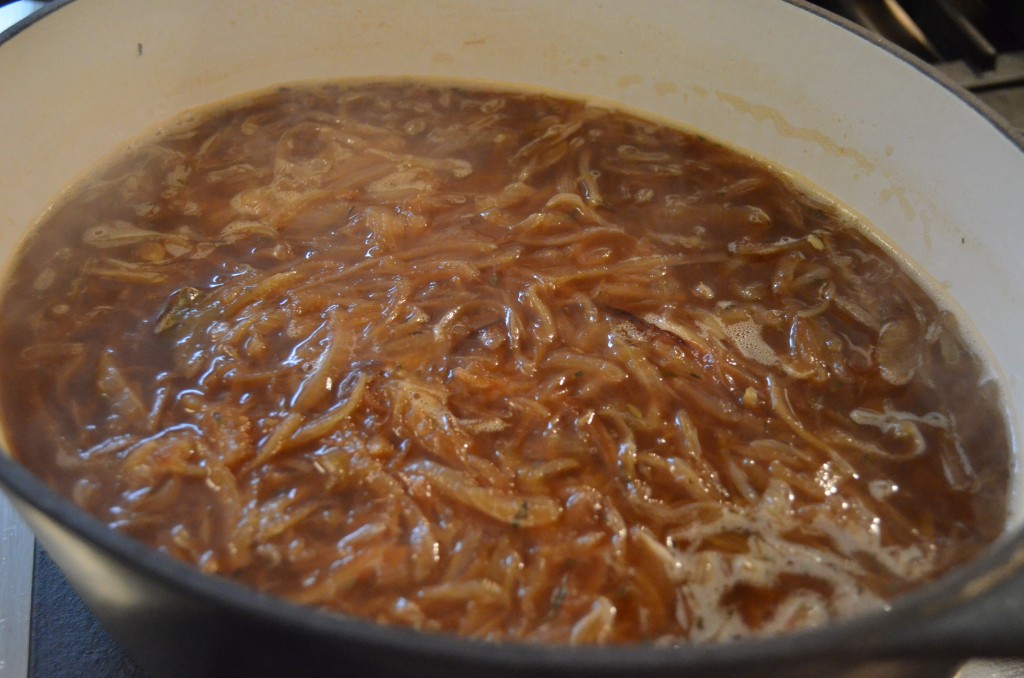 onions and broth simmering in a cast iron pot